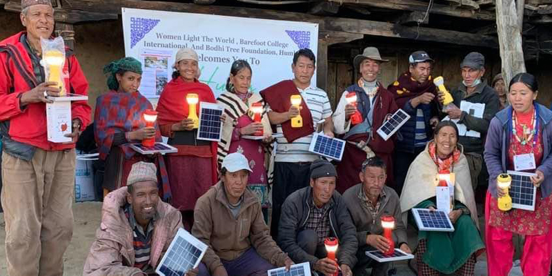 Pic 02: Local families holding their solar Panel distributed by Women Light the World